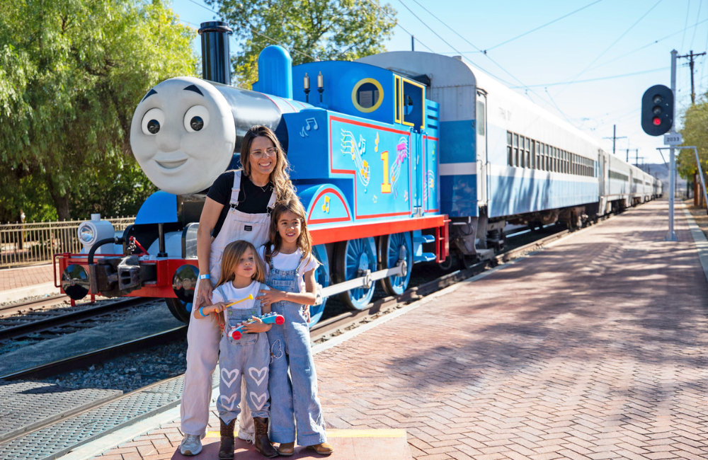 Family posing in front of Thomas the Tank Engine