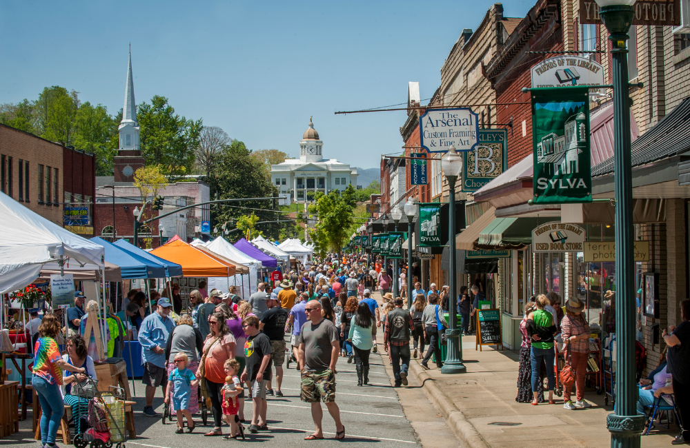 People on the street with the historic courthouse and mountains behind